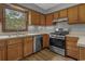 Updated kitchen featuring stainless steel appliances, wooden cabinets, and lots of natural light at 124 Wicklow Way, Pawleys Island, SC 29585