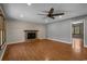 Inviting living room with hardwood floors, brick fireplace, ceiling fan, and ample natural light at 124 Wicklow Way, Pawleys Island, SC 29585