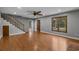 Spacious living room boasts hardwood floors, a staircase, and natural light streaming through a large window at 124 Wicklow Way, Pawleys Island, SC 29585