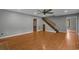 Spacious living room with gleaming hardwood floors, staircase, and an inviting open layout at 124 Wicklow Way, Pawleys Island, SC 29585