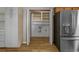 Kitchen pantry with storage and stainless steel refrigerator at 124 Wicklow Way, Pawleys Island, SC 29585