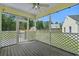 Inviting screened porch with ceiling fan and decorative lattice, perfect for relaxing outdoors at 124 Wicklow Way, Pawleys Island, SC 29585