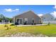 This backyard has a cozy patio, perfect for outdoor entertaining and enjoying the serene surroundings at 125 Foxford Dr., Conway, SC 29526
