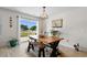 Bright dining area features a wooden table, rustic bench, and sliding glass doors leading to outdoor spaces at 125 Foxford Dr., Conway, SC 29526