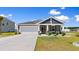 Charming single-story home with a well-manicured lawn, covered porch, and attached two-car garage at 125 Foxford Dr., Conway, SC 29526