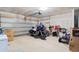 Spacious garage with motorcycle, lawn care equipment, and overhead door at 125 Foxford Dr., Conway, SC 29526