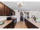 Bright eat-in kitchen showcases stainless steel appliances, stylish dark wood cabinets and a spacious island with sink at 125 Foxford Dr., Conway, SC 29526