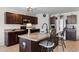 Well-lit kitchen features stainless steel appliances, a kitchen island with bar seating, and dark wood cabinets at 125 Foxford Dr., Conway, SC 29526