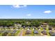 New homes line streets of Gathering-friendly neighborhood near green forest and under clear blue skies at 125 Foxford Dr., Conway, SC 29526