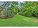Green lawn and shrubbery highlight the large backyard at 1305 Forest View Rd., Conway, SC 29526