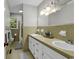The bathroom offers a double vanity, a large window, and a shower-tub combo with tan tile at 1305 Forest View Rd., Conway, SC 29526