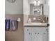Bathroom featuring a single sink vanity with a pastel tile surround and a large mirror and soft towels at 1305 Forest View Rd., Conway, SC 29526
