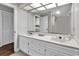 Bathroom vanity with double sinks and white cabinetry, under a large mirror and unique lighting at 1305 Forest View Rd., Conway, SC 29526