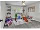 Playful bedroom designed with built-in shelving, lots of toys, and a swing set at 1305 Forest View Rd., Conway, SC 29526