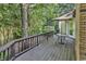 Exterior deck boasts wood plank flooring, dark railing, and patio furniture to enjoy the backyard at 1305 Forest View Rd., Conway, SC 29526