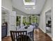 Light-filled dining room showcasing hardwood floors, a skylight, and access to an outdoor area at 1305 Forest View Rd., Conway, SC 29526