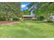 Charming single-story home featuring a well-maintained lawn and mature trees creating curb appeal at 1305 Forest View Rd., Conway, SC 29526