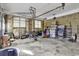 View of cluttered interior of two-car garage with exposed brick wall and open ceiling beams at 1305 Forest View Rd., Conway, SC 29526