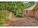 View of the backyard with wooden fence, brick exterior, and trimmed shrubs at 1305 Forest View Rd., Conway, SC 29526