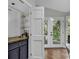 Cozy wet bar featuring a sink, glass shelving, and convenient access to the outdoor deck through double doors at 1305 Forest View Rd., Conway, SC 29526