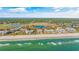 Breathtaking aerial view featuring oceanfront condos, a beach, and lush surroundings at 145 South Dunes Dr. # 308, Pawleys Island, SC 29585