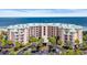 Beautiful aerial view of the condo building with ocean views, green roof and a roundabout entrance at 145 South Dunes Dr. # 308, Pawleys Island, SC 29585
