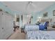 Inviting bedroom with two beds, ceiling fan, and view into en-suite bathroom at 145 South Dunes Dr. # 308, Pawleys Island, SC 29585