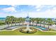 Beautiful property entrance with palm trees, a fountain, and picturesque landscaping at 145 South Dunes Dr. # 308, Pawleys Island, SC 29585