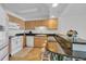 Kitchenette with wood cabinets, white appliances, a breakfast bar and seating at 145 South Dunes Dr. # 308, Pawleys Island, SC 29585