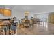 Open floorplan with stone floors, a glass dining table, a kitchen and living room with shutters at 145 South Dunes Dr. # 308, Pawleys Island, SC 29585