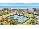 Aerial view showcasing tennis courts next to condos, beach, and parking at 145 South Dunes Dr. # 308, Pawleys Island, SC 29585