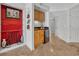 Built-in wet bar with wood cabinets, beverage cooler, red accent wall with artwork and stone floors at 145 South Dunes Dr. # 308, Pawleys Island, SC 29585