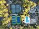 Overhead view showcasing tennis courts and a community pool surrounded by lush greenery at 1501 Harbor Dr., North Myrtle Beach, SC 29582