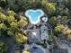 Aerial view of a community pool area surrounded by mature trees and well-maintained landscaping at 1501 Harbor Dr., North Myrtle Beach, SC 29582