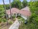Beautiful aerial view of the property showcasing the driveway, tiled roof, and lush landscaping at 1501 Harbor Dr., North Myrtle Beach, SC 29582