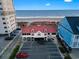 Aerial view of the building, parking, and the beach with ocean views in the background at 1501 Harbor Dr., North Myrtle Beach, SC 29582