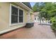 Exterior shot of the backyard with a brick patio and outdoor seating near the house and a shed with a matching roof at 1501 Harbor Dr., North Myrtle Beach, SC 29582