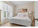 Bright bedroom with a large window, white furniture, and wooden floors at 1501 Harbor Dr., North Myrtle Beach, SC 29582