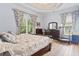 Comfortable bedroom with blue accents, large windows, and hardwood floors at 1501 Harbor Dr., North Myrtle Beach, SC 29582