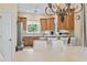 Neutral dining area adjacent to a kitchen with wood cabinets and eat-in bar seating at 1501 Harbor Dr., North Myrtle Beach, SC 29582