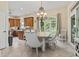 Bright dining area with a chandelier, neutral decor, and views of nature at 1501 Harbor Dr., North Myrtle Beach, SC 29582