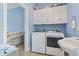 Laundry room featuring upper cabinets, a washer, dryer and sink at 1501 Harbor Dr., North Myrtle Beach, SC 29582