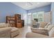 Living room with comfortable seating, bookshelves, and a glass door to the outside at 1501 Harbor Dr., North Myrtle Beach, SC 29582