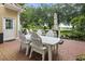 Inviting outdoor patio features a brick surface, white Adirondack furniture, and picturesque golf course views at 1501 Harbor Dr., North Myrtle Beach, SC 29582