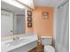 A clean bathroom features a white vanity, toilet, and shower/tub combination with peach walls and tiled flooring at 1501 S Ocean Blvd. # 351, Myrtle Beach, SC 29577