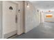 Hallway with white walls and gray flooring leads to unit 351 with secure entry system at 1501 S Ocean Blvd. # 351, Myrtle Beach, SC 29577
