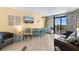 Cozy living room with dining area, comfortable seating, a TV, and balcony access at 1501 S Ocean Blvd. # 351, Myrtle Beach, SC 29577