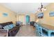 Bright living room with dining table, couch, beach decor, and balcony access at 1501 S Ocean Blvd. # 351, Myrtle Beach, SC 29577