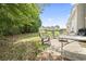 Backyard featuring patio and lawn with mature trees at 1535 Harlow Ct., Myrtle Beach, SC 29579