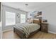 Bright bedroom with views to the outside through two windows and a decorative headboard at 1535 Harlow Ct., Myrtle Beach, SC 29579